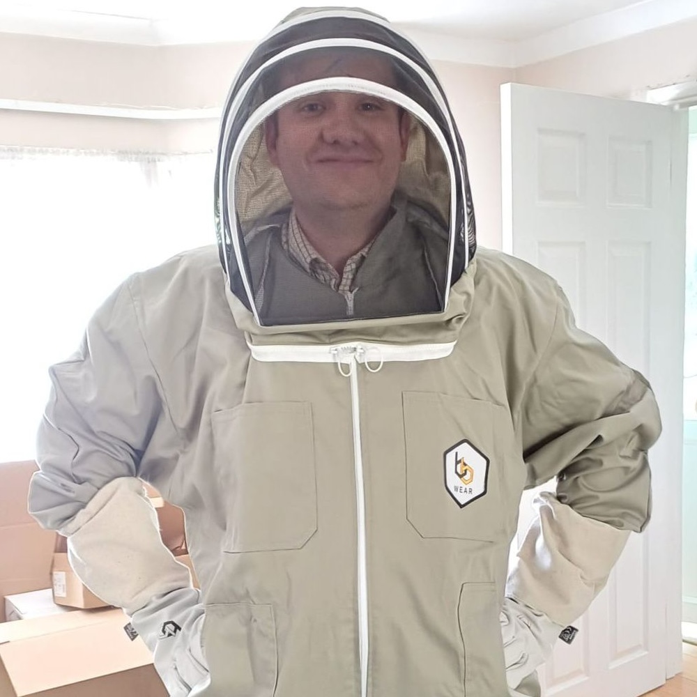 Pest control technician in a bee suit